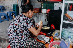 Lady making banh mi, Hanoi